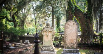 Tombstones and gravesite at Bonaventure Cemetery, Savannah, Georgia. Live Oak trees and Spanish Moss in the background. Shallow DOF.
