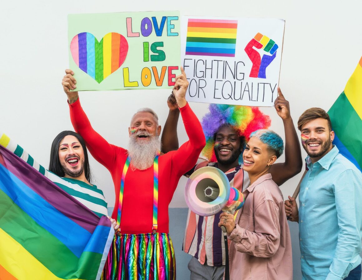 Members of the LGBTQ community hold up signs at the Pride parade. 