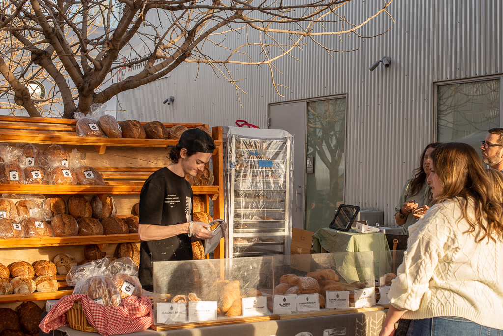 Shopper buying artisanal bread from Agritopia in Gilbert, Arizona.